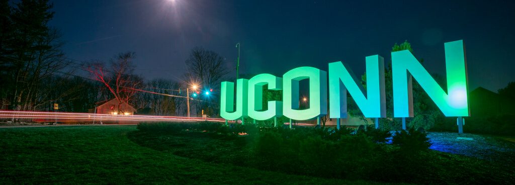 UConn sign lit up green for sustainability (and apparently st. patricks day)