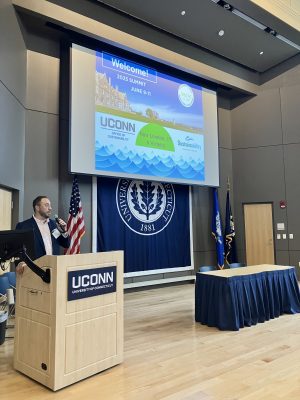 Patrick McKee speaking at a podium at NECSC conference.
