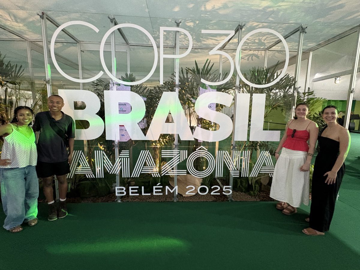 Students in front of a COP30 sign.