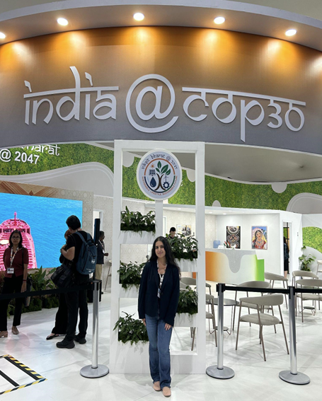 Kanika in front of the India COP30 Pavilion.